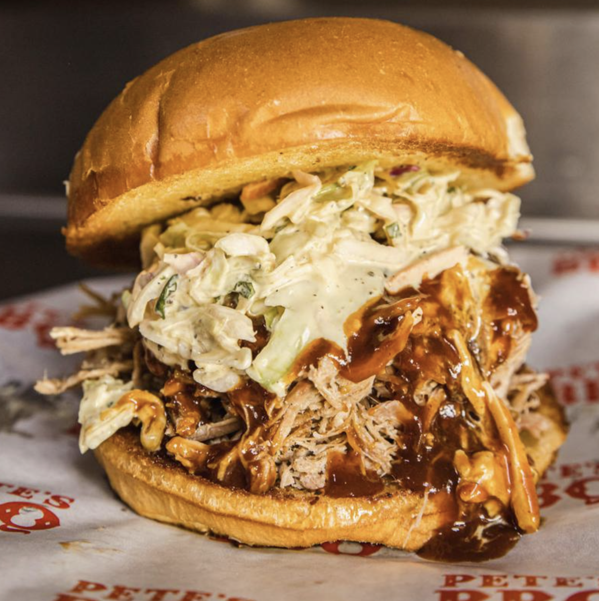 Pulled pork burger stacked high with pulled pork and coleslaw